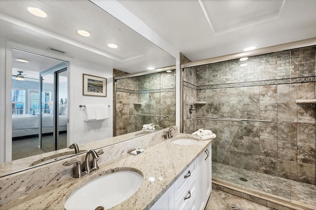 7554 Palm Island Dr S Unit 1813, Placida, FL 33946 - ensuite bathroom featuring double vanity, a tile shower, a tray ceiling, recessed lighting, and ceiling fan