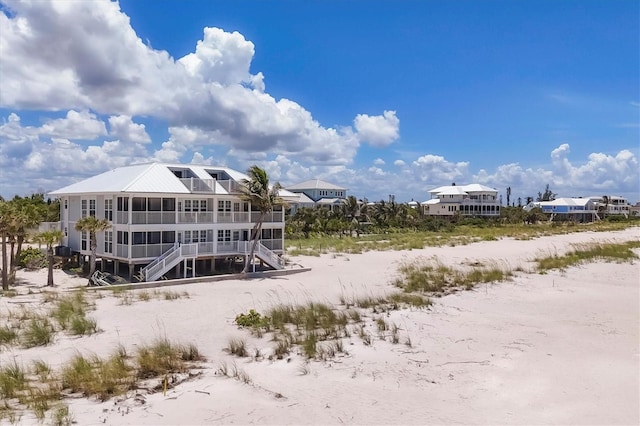 7554 Palm Island Dr S Unit 1813, Placida, FL 33946 - back of house featuring stairway and a sunroom