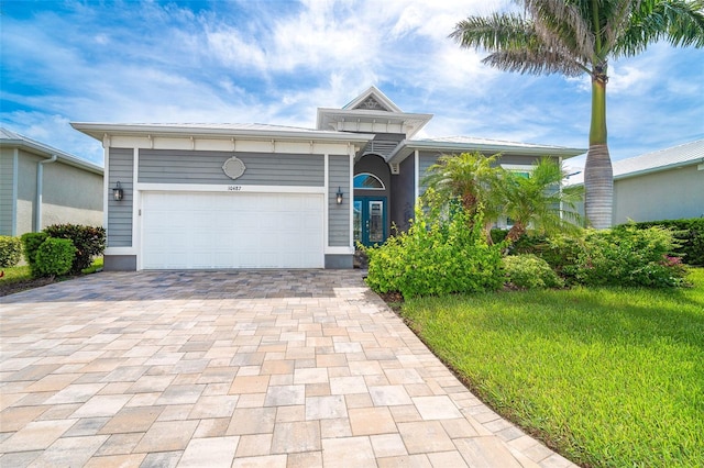 10487 Coquina Ct, Placida, FL 33946 - ranch-style house with decorative driveway and an attached garage