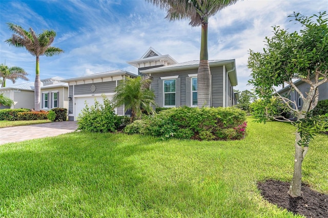 10487 Coquina Ct, Placida, FL 33946 - view of front of property featuring an attached garage, driveway, and a front lawn