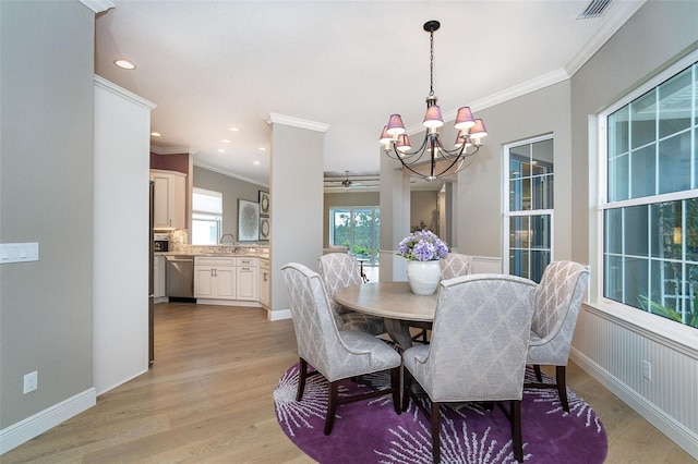 10487 Coquina Ct, Placida, FL 33946 - dining room with crown molding, a chandelier, light wood-style floors, and recessed lighting