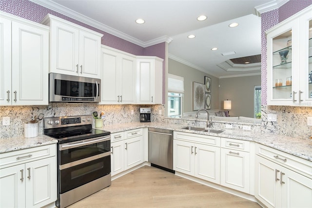 10487 Coquina Ct, Placida, FL 33946 - kitchen with stainless steel appliances, light wood-style flooring, glass insert cabinets, recessed lighting, and light stone countertops