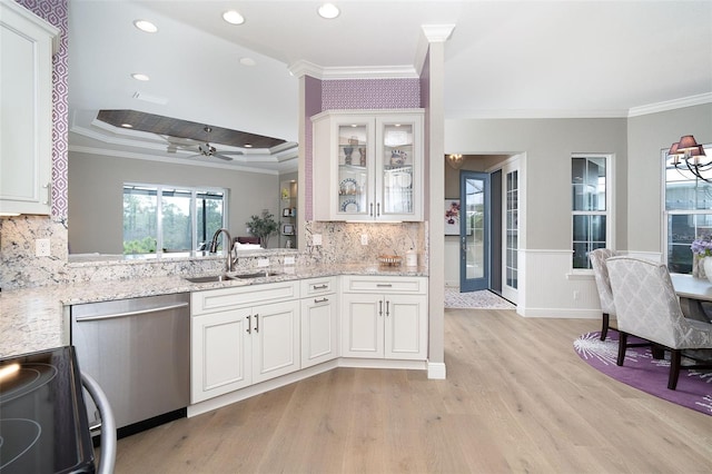 10487 Coquina Ct, Placida, FL 33946 - kitchen featuring stainless steel dishwasher, range with electric stovetop, ornamental molding, light wood-type flooring, and light stone countertops