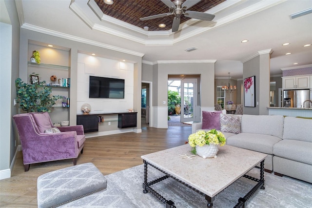 10487 Coquina Ct, Placida, FL 33946 - living area with a tray ceiling, ornamental molding, a chandelier, light wood finished floors, and ceiling fan