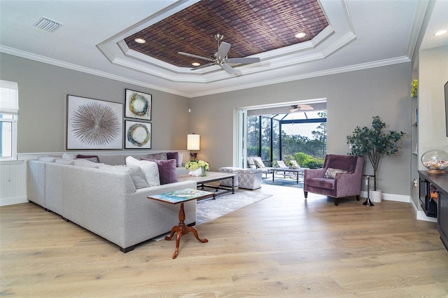 10487 Coquina Ct, Placida, FL 33946 - living room featuring a tray ceiling, a ceiling fan, wood finished floors, ornamental molding, and recessed lighting
