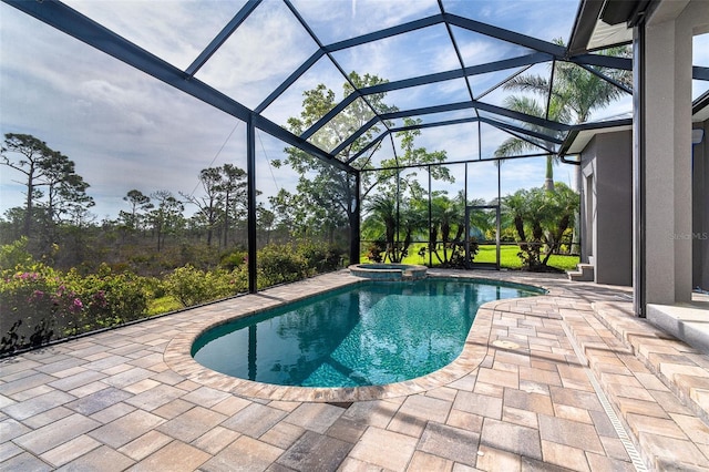 10487 Coquina Ct, Placida, FL 33946 - view of pool featuring a patio area, a pool with connected hot tub, and glass enclosure