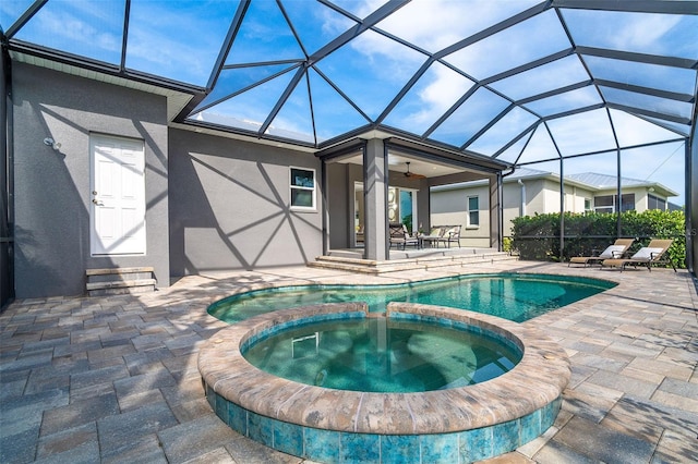 10487 Coquina Ct, Placida, FL 33946 - view of swimming pool featuring a patio area, a pool with connected hot tub, ceiling fan, and a lanai