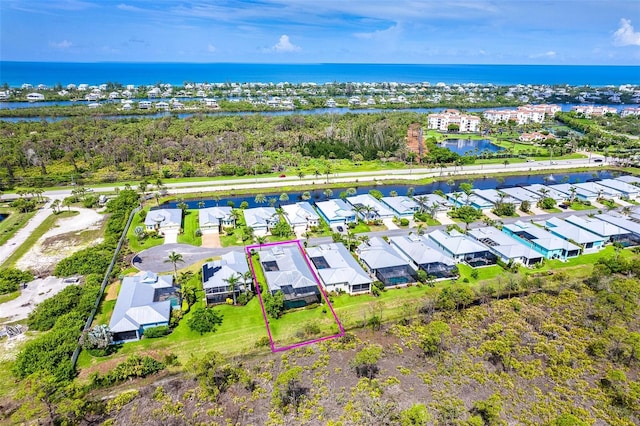 10487 Coquina Ct, Placida, FL 33946 - aerial perspective of suburban area with property parcel outlined and a nearby body of water
