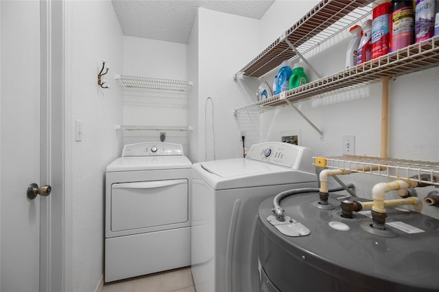 15 Oakland Hills Pl, Rotonda West, FL 33947 - washroom featuring washing machine and clothes dryer, a textured ceiling, and light tile patterned floors