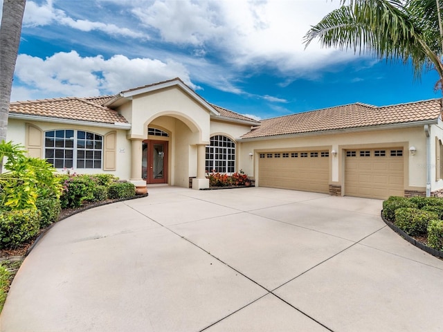 117 Abercrombie Ave, Englewood, FL 34223 - mediterranean / spanish house with french doors, a tiled roof, and stucco siding