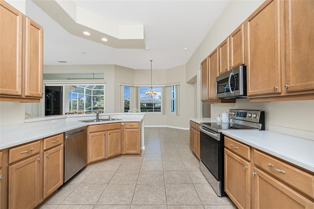 117 Abercrombie Ave, Englewood, FL 34223 - kitchen featuring stainless steel appliances, a peninsula, recessed lighting, light tile patterned flooring, and light countertops