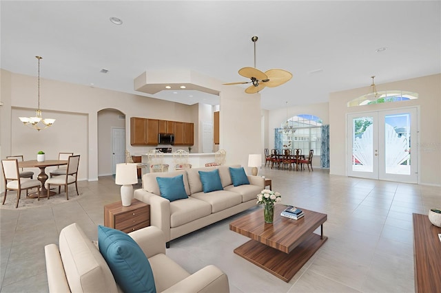 117 Abercrombie Ave, Englewood, FL 34223 - living room with arched walkways, a chandelier, light tile patterned floors, french doors, and a ceiling fan