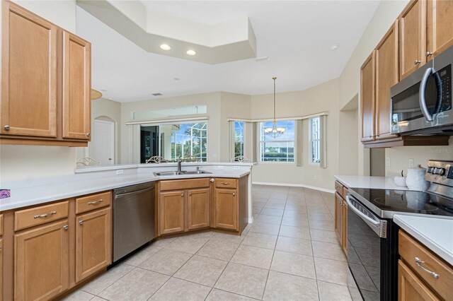 117 Abercrombie Ave, Englewood, FL 34223 - kitchen with stainless steel appliances, a peninsula, light tile patterned floors, recessed lighting, and light countertops