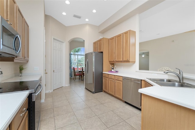 117 Abercrombie Ave, Englewood, FL 34223 - kitchen featuring stainless steel appliances, arched walkways, light tile patterned floors, light countertops, and recessed lighting