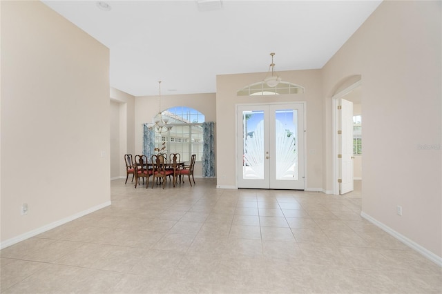 117 Abercrombie Ave, Englewood, FL 34223 - foyer featuring french doors, light tile patterned floors, and a chandelier