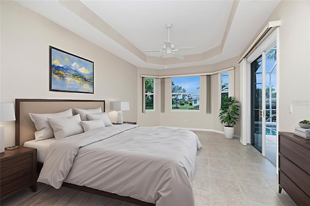 117 Abercrombie Ave, Englewood, FL 34223 - bedroom featuring access to outside, a tray ceiling, ceiling fan, and light tile patterned floors