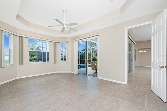 117 Abercrombie Ave, Englewood, FL 34223 - unfurnished room with a tray ceiling, a chandelier, ceiling fan, and light tile patterned flooring