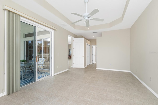 117 Abercrombie Ave, Englewood, FL 34223 - empty room featuring a ceiling fan, a raised ceiling, and light tile patterned flooring