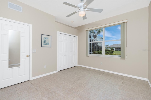 117 Abercrombie Ave, Englewood, FL 34223 - unfurnished bedroom featuring a closet, light tile patterned flooring, and ceiling fan