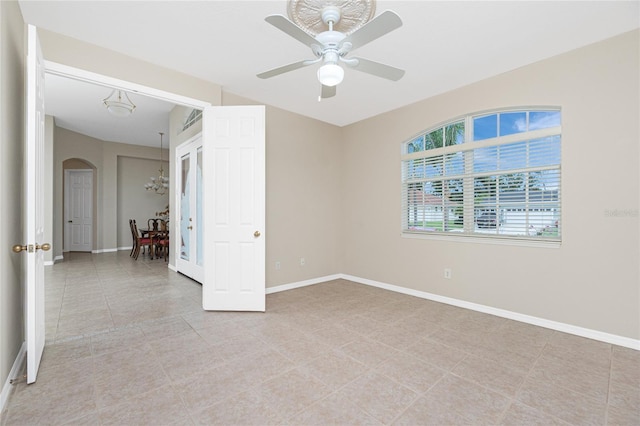 117 Abercrombie Ave, Englewood, FL 34223 - empty room featuring arched walkways, ceiling fan, and light tile patterned floors