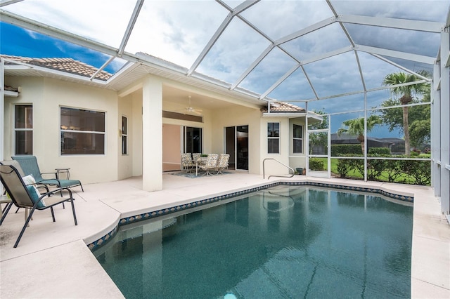 117 Abercrombie Ave, Englewood, FL 34223 - outdoor pool featuring a patio, glass enclosure, and ceiling fan