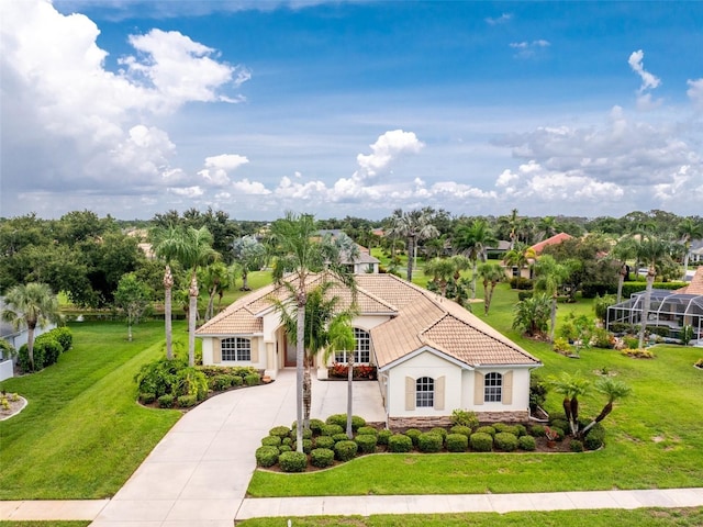117 Abercrombie Ave, Englewood, FL 34223 - mediterranean / spanish-style house with a tile roof, stucco siding, driveway, stone siding, and a front lawn