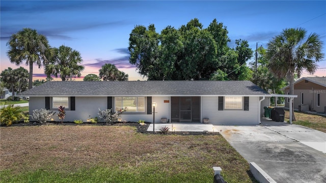 1730 Bluebird Ln, Englewood, FL 34224 - ranch-style house featuring driveway, a front yard, and a shingled roof