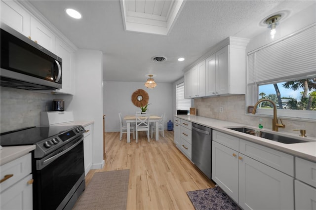 1730 Bluebird Ln, Englewood, FL 34224 - kitchen featuring stainless steel appliances, decorative backsplash, light countertops, plenty of natural light, and recessed lighting