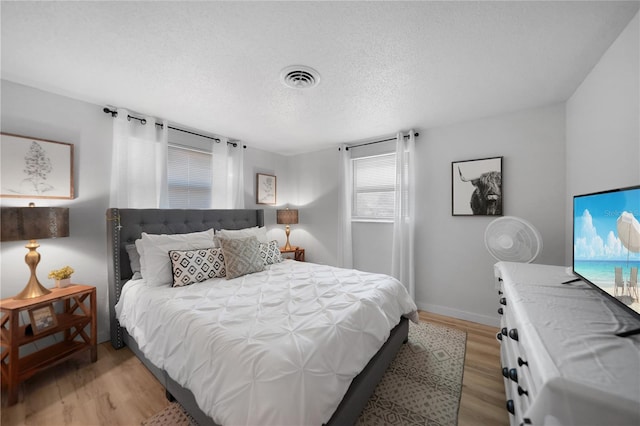 1730 Bluebird Ln, Englewood, FL 34224 - bedroom featuring light wood-style floors and a textured ceiling
