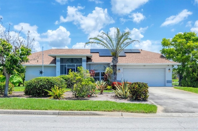 727 Rotonda Cir, Rotonda West, FL 33947 - single story home featuring stucco siding, a garage, roof mounted solar panels, and concrete driveway