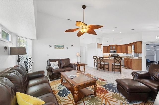 727 Rotonda Cir, Rotonda West, FL 33947 - living area featuring light tile patterned flooring, ceiling fan, and a high ceiling