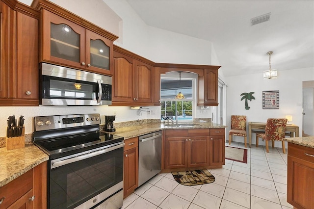 727 Rotonda Cir, Rotonda West, FL 33947 - kitchen with stainless steel appliances, light stone countertops, and brown cabinetry