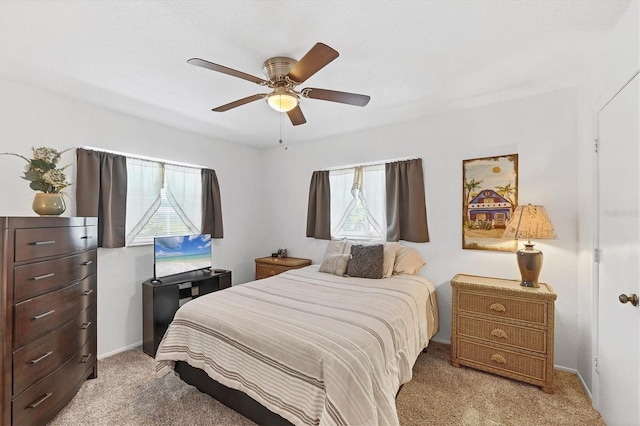 727 Rotonda Cir, Rotonda West, FL 33947 - bedroom featuring multiple windows, light colored carpet, and a ceiling fan