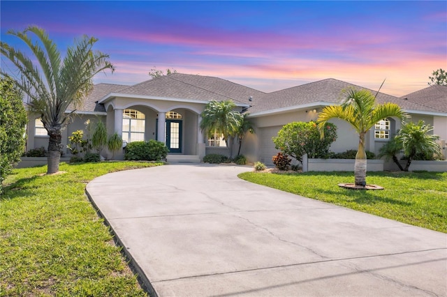 39 Pine Valley Ct, Rotonda West, FL 33947 - single story home featuring curved driveway, stucco siding, and a lawn