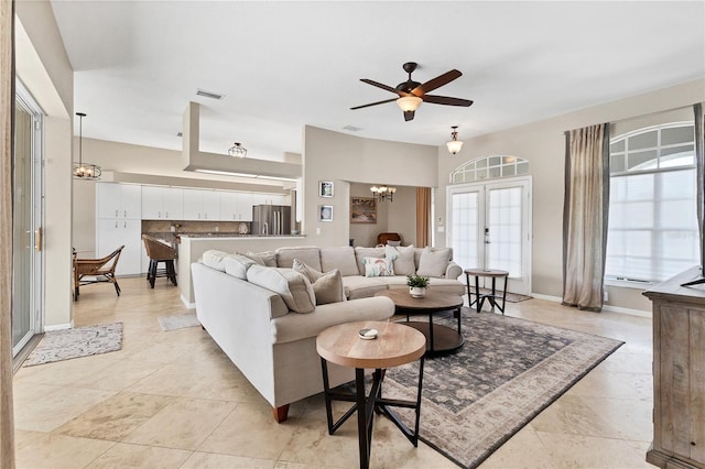 39 Pine Valley Ct, Rotonda West, FL 33947 - living room featuring french doors, a chandelier, a ceiling fan, and light tile patterned floors