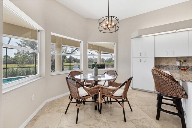 39 Pine Valley Ct, Rotonda West, FL 33947 - dining room with plenty of natural light, a chandelier, and light tile patterned floors