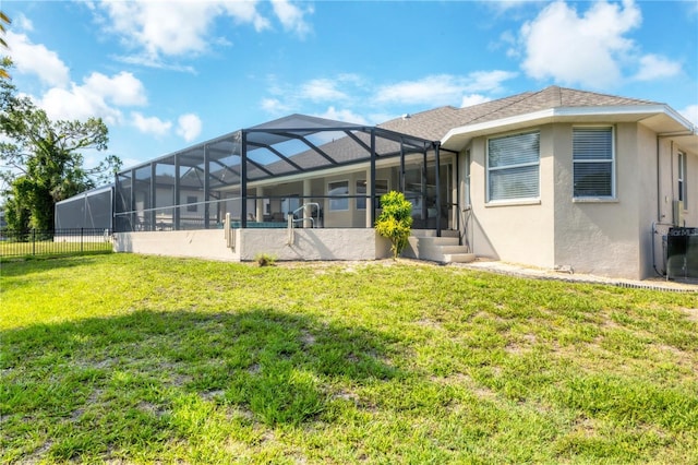 39 Pine Valley Ct, Rotonda West, FL 33947 - rear view of property featuring stucco siding and glass enclosure
