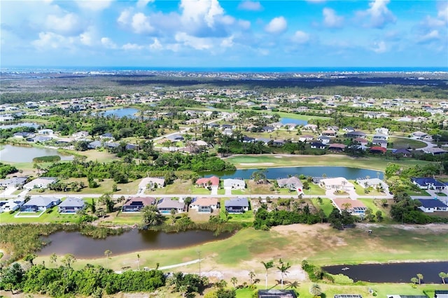 39 Pine Valley Ct, Rotonda West, FL 33947 - aerial view of property and surrounding area with nearby suburban area and a large body of water