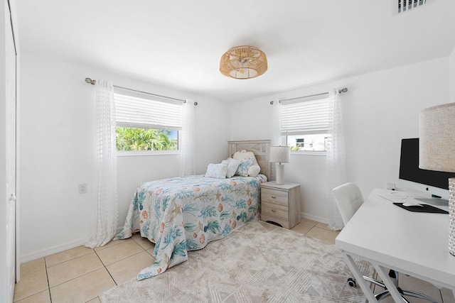 1060 Haste Ln, Englewood, FL 34223 - bedroom with multiple windows, light tile patterned flooring, and an office area
