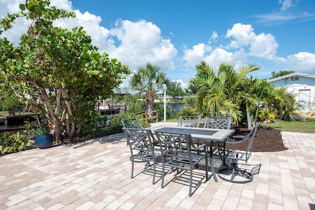 1060 Haste Ln, Englewood, FL 34223 - view of patio / terrace featuring outdoor dining area and a water view