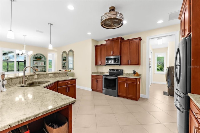 10029 Boylston St, Port Charlotte, FL 33981 - kitchen with stainless steel appliances, a chandelier, light stone counters, light tile patterned flooring, and decorative light fixtures