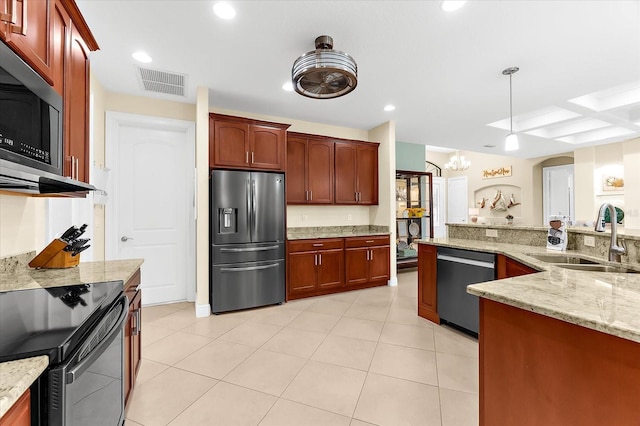 10029 Boylston St, Port Charlotte, FL 33981 - kitchen with stainless steel appliances, a chandelier, decorative light fixtures, light stone counters, and recessed lighting
