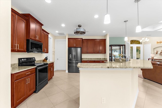 10029 Boylston St, Port Charlotte, FL 33981 - kitchen with black appliances, recessed lighting, hanging light fixtures, light stone countertops, and a breakfast bar