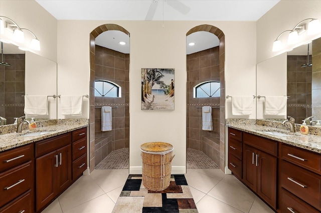 10029 Boylston St, Port Charlotte, FL 33981 - full bathroom with a walk in shower, two vanities, ceiling fan, and tile patterned floors