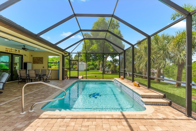 10029 Boylston St, Port Charlotte, FL 33981 - outdoor pool featuring a patio area, a storage shed, a yard, outdoor dining space, and glass enclosure