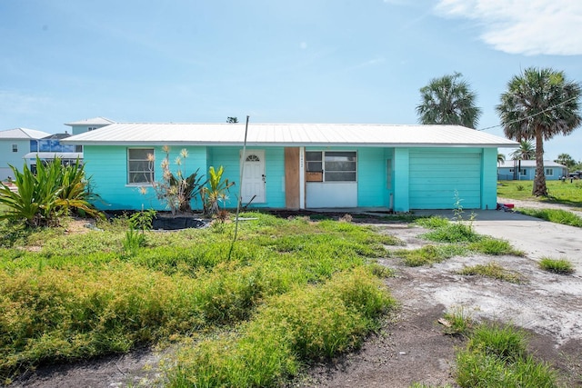 10452 Raymond St, Englewood, FL 34224 - ranch-style house with an attached garage, driveway, and a metal roof