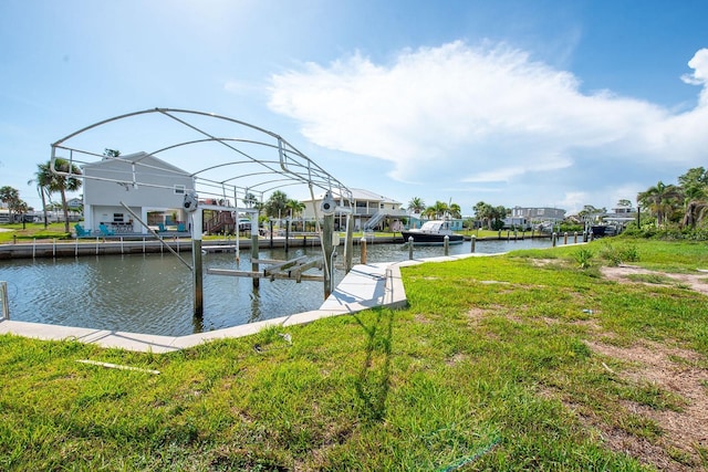 10452 Raymond St, Englewood, FL 34224 - dock area with boat lift, a water view, and a yard