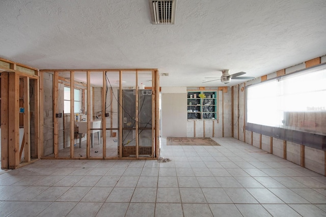 10452 Raymond St, Englewood, FL 34224 - misc room with a ceiling fan and a textured ceiling