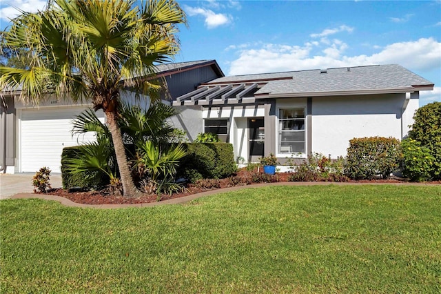 609 Deerwood Ave, Englewood, FL 34223 - view of front of home featuring an attached garage, stucco siding, a front yard, and roof with shingles
