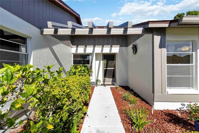 609 Deerwood Ave, Englewood, FL 34223 - view of exterior entry featuring stucco siding